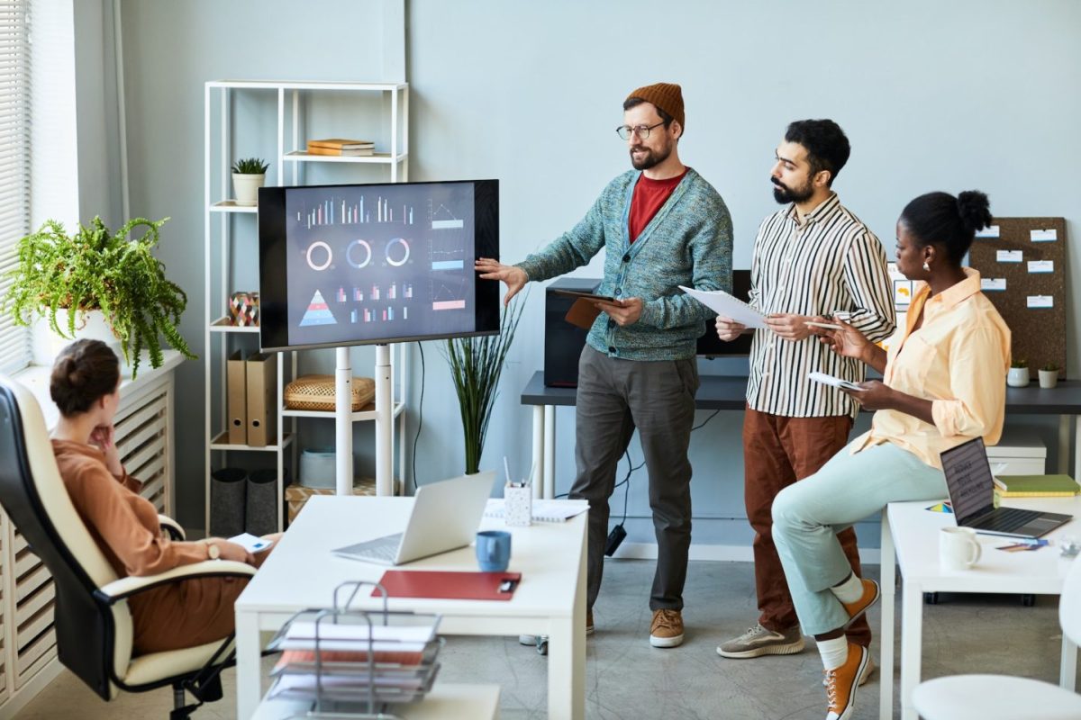 young-businessman-in-casualwear-explaining-his-colleagues-financial-data-e1701763589276